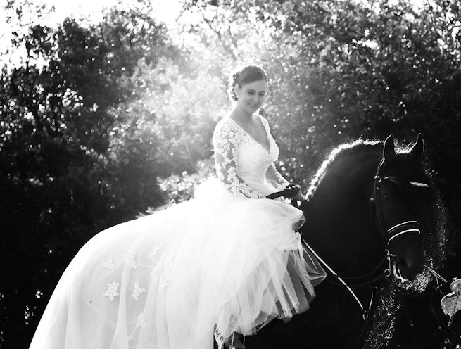 Leeanne Taylor on her wedding day, riding Black Friesian Stallion dressed as Unicorn
